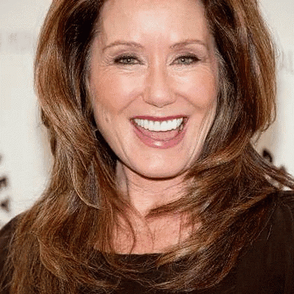 a close up of a woman 's face with a smile on her face .