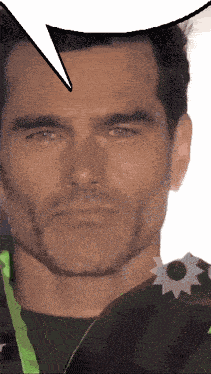 a close up of a man 's face with a speech bubble behind him