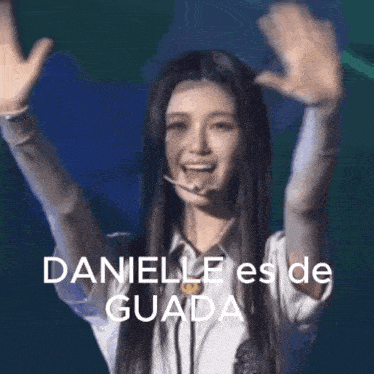 a woman is raising her arms in the air with the words danielle es de guada on the bottom .