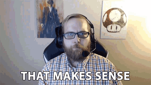 a man with glasses and a beard is wearing headphones and says that makes sense