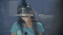 a woman wearing glasses and headphones is singing into a microphone