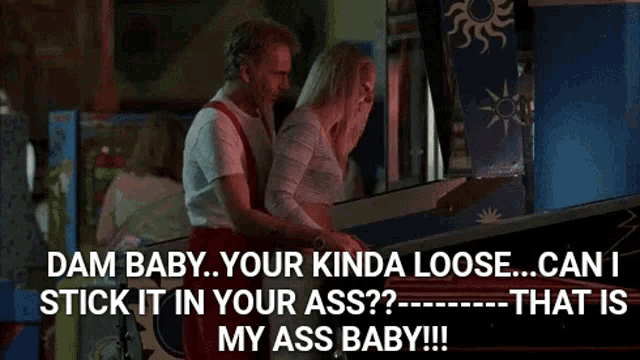 a man and a woman are playing a pinball machine and the woman is asking the man to stick it in her ass .