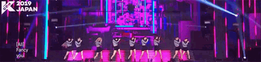 a group of women are dancing on a stage in front of a sign that says 2019 kpop japan