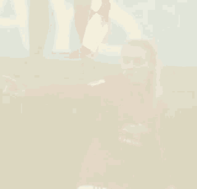 a blurry picture of a man in a red shirt holding a flag