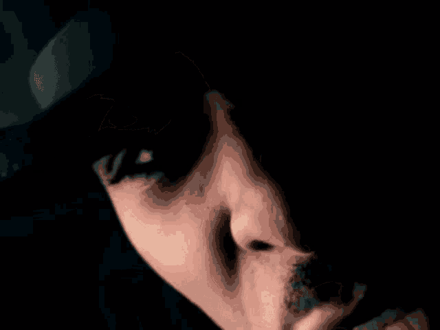 a close up of a person 's face with a mustache