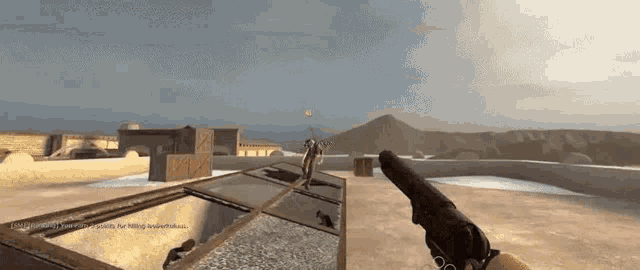 a person is holding a gun in a video game with a mountain in the background ..
