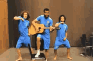 a man playing a guitar while two other men dance