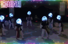 a group of people are dancing in front of a sign that says ' i 'm a korean ' on it