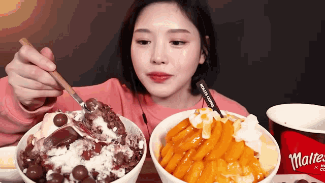 a woman is eating a bowl of ice cream with a spoon in it