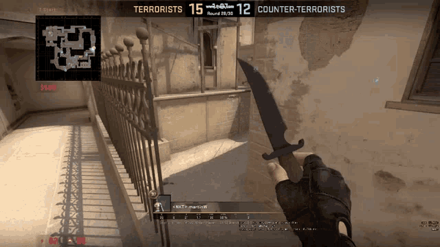 a person holding a knife in front of a screen that says terrorists