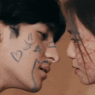 a man and woman are looking at each other with hearts and stars drawn on their faces