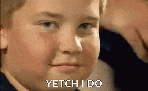 a young boy is making a funny face and says yetchi do .