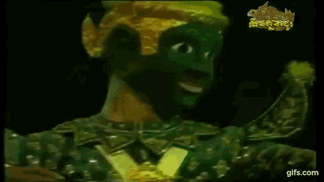 a cartoon character with a green face and a yellow hat is smiling .