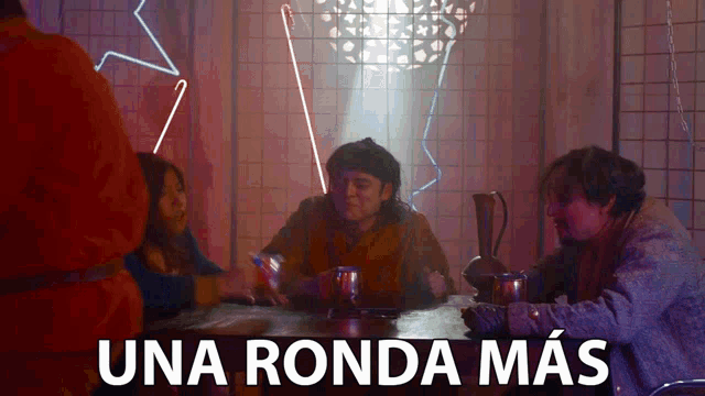 a group of people sitting around a table with the words una ronda mas written on the bottom