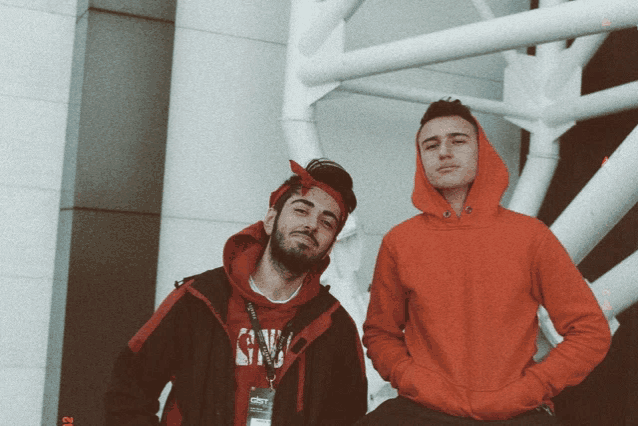 two men standing next to each other one wearing a sweatshirt that says gnw