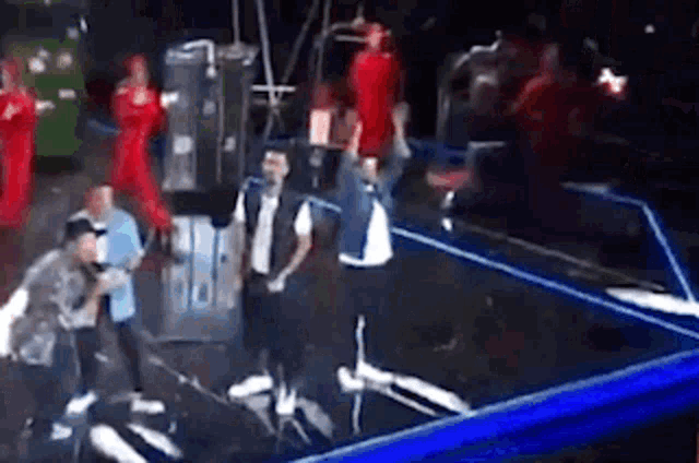 a group of people are standing on a stage in front of a microphone .