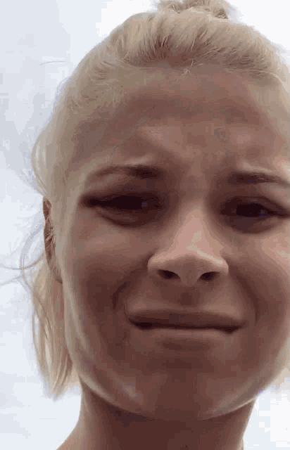 a close up of a woman 's face making a face