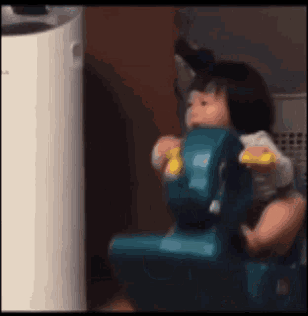 a baby is playing with a toy car in a room