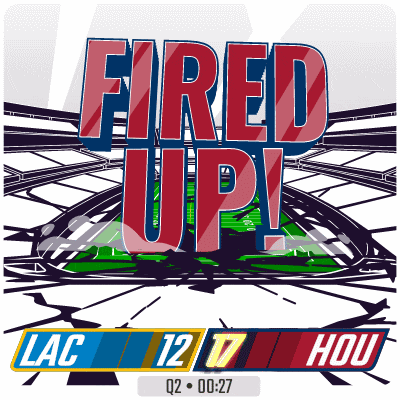 a sign that says fired up on it with a football field in the background