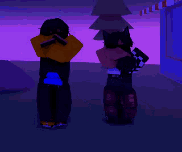 a boy and a girl are kneeling down in front of a purple background .
