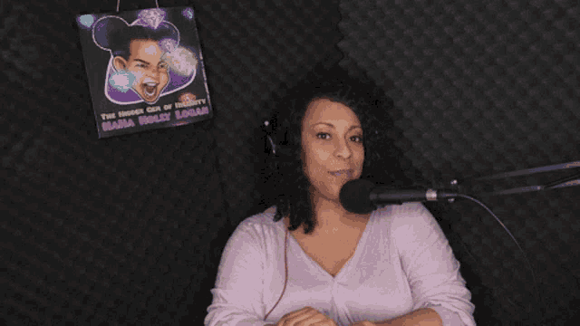 a woman sitting in front of a microphone with a sign behind her that says mama holly sugar