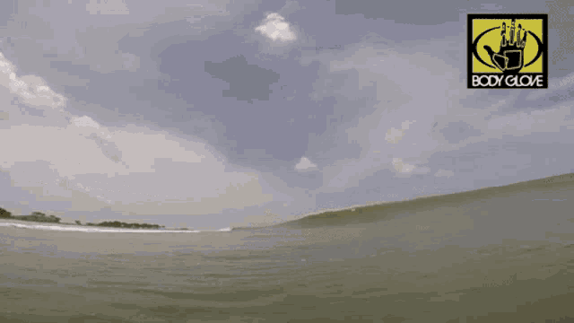a body glove logo is displayed above a wave in the ocean