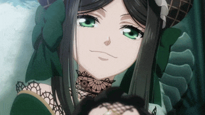 a girl with green eyes and black hair is wearing a green dress
