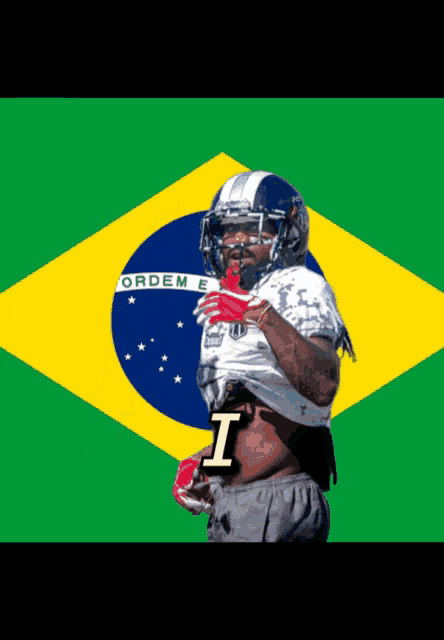 a football player stands in front of a flag that says ordem e