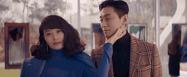 a man and a woman are standing next to each other