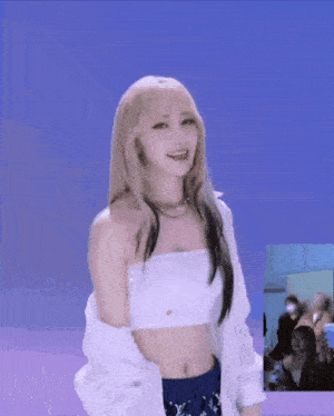 a woman with blonde hair is wearing a white crop top and blue louis vuitton shorts