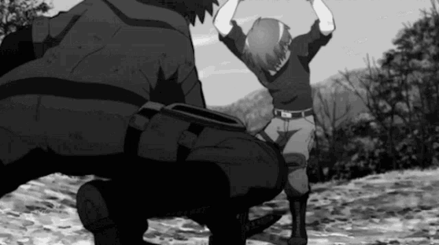 a black and white photo of a man kneeling down next to another man with his arms in the air