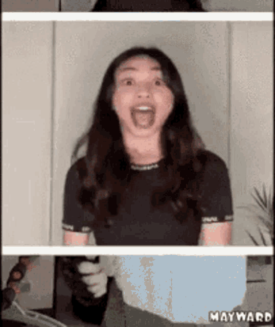 a woman in a black shirt is making a surprised face .