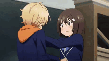 a boy and a girl are standing next to each other in a room .