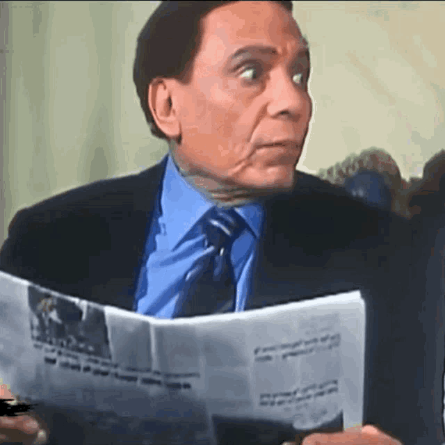 a man in a suit is reading a newspaper