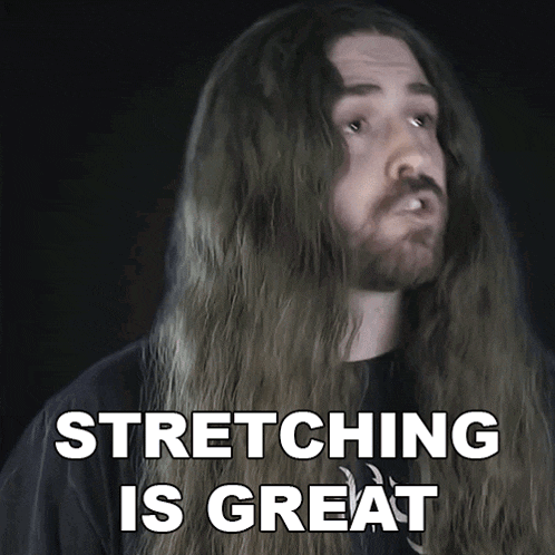 a man with long hair and a beard is stretching