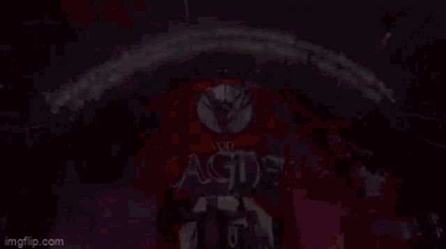 a man is standing in front of a stage with a sign that says ' a & g ' on it
