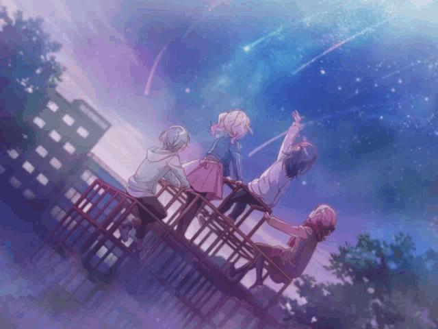 a group of people sitting on a bridge looking up at the sky