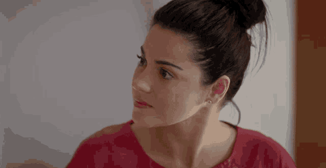 a woman has a tattoo on her ear that says ' i love you '