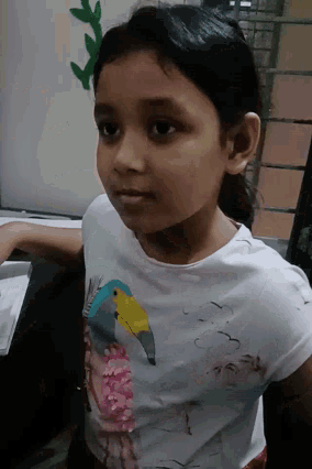a girl wearing a white shirt with a bird on it