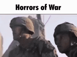 a couple of soldiers standing next to each other in a field .