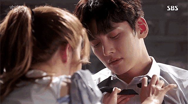 a man and a woman are kissing with sbs written on the bottom of the screen