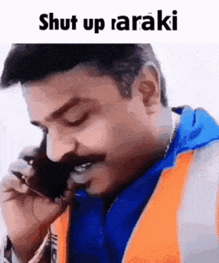 a man with a mustache is talking on a cell phone with the words shut up araki above him