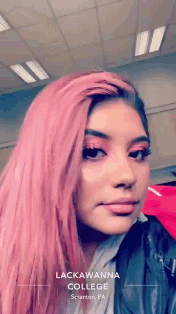 a girl with pink hair is wearing a black jacket and is from lackawanna college scranton pa