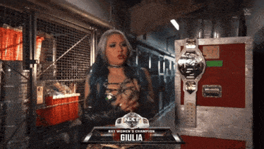 a female wrestler named giulia is standing in a hallway