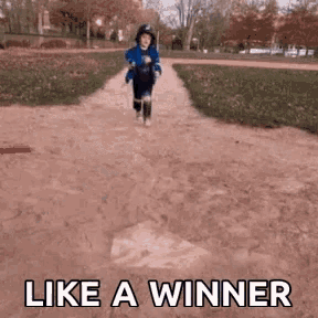 a little boy is running down a dirt path with the words like a winner written on the bottom .
