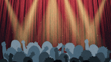 a crowd of people standing in front of a stage with a red curtain