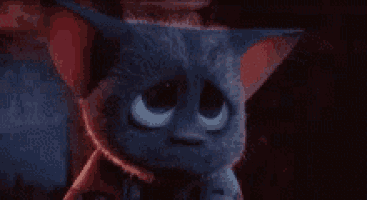 a close up of a cartoon cat with big eyes and a hat .