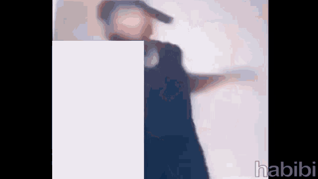a blurry picture of a man wearing a hat and dancing .