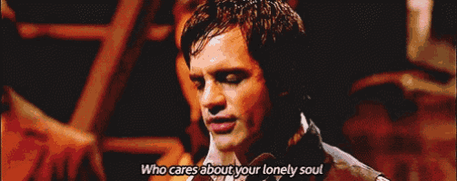 a man singing a song with the words who cares about your lonely soul below him