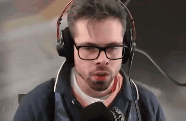 a man wearing glasses and headphones is talking into a microphone ..